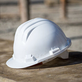 white-construction-helmet-on-the-ground-under-the-sunlight